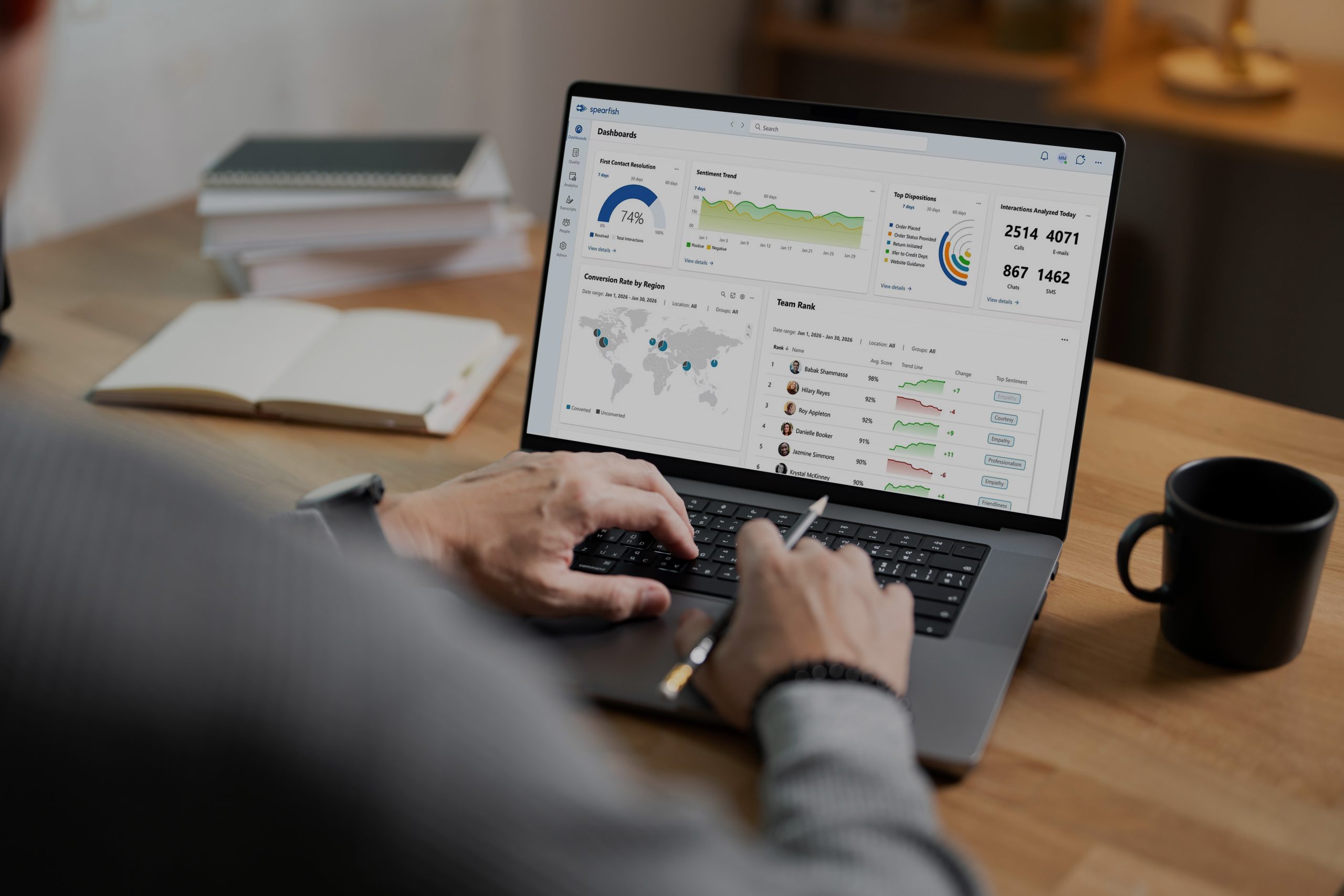Analyst reviewing contact center dashboards on a laptop